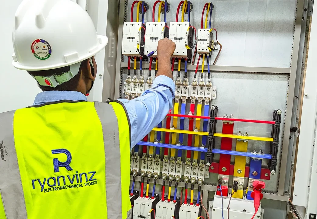 Ryan Vinz technician wiring contactors inside an LT power panel